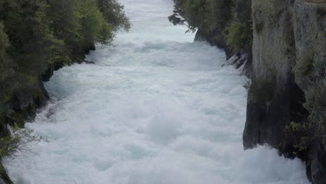 A-zoomed-in-and-compressed-shot-looking-down-the-Huka-Falls-in-Taupo,-NZ