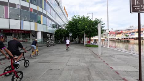 people riding bicycles in a city plaza