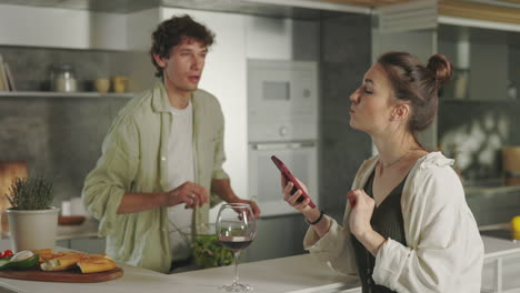 a couple cooking and interacting in a modern kitchen