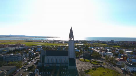 aerial arcing shot of the famous central church in reykjavik, the hallgrimskirkja