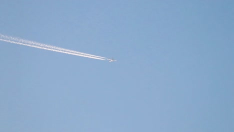 airplane in clear blue sky from the ground