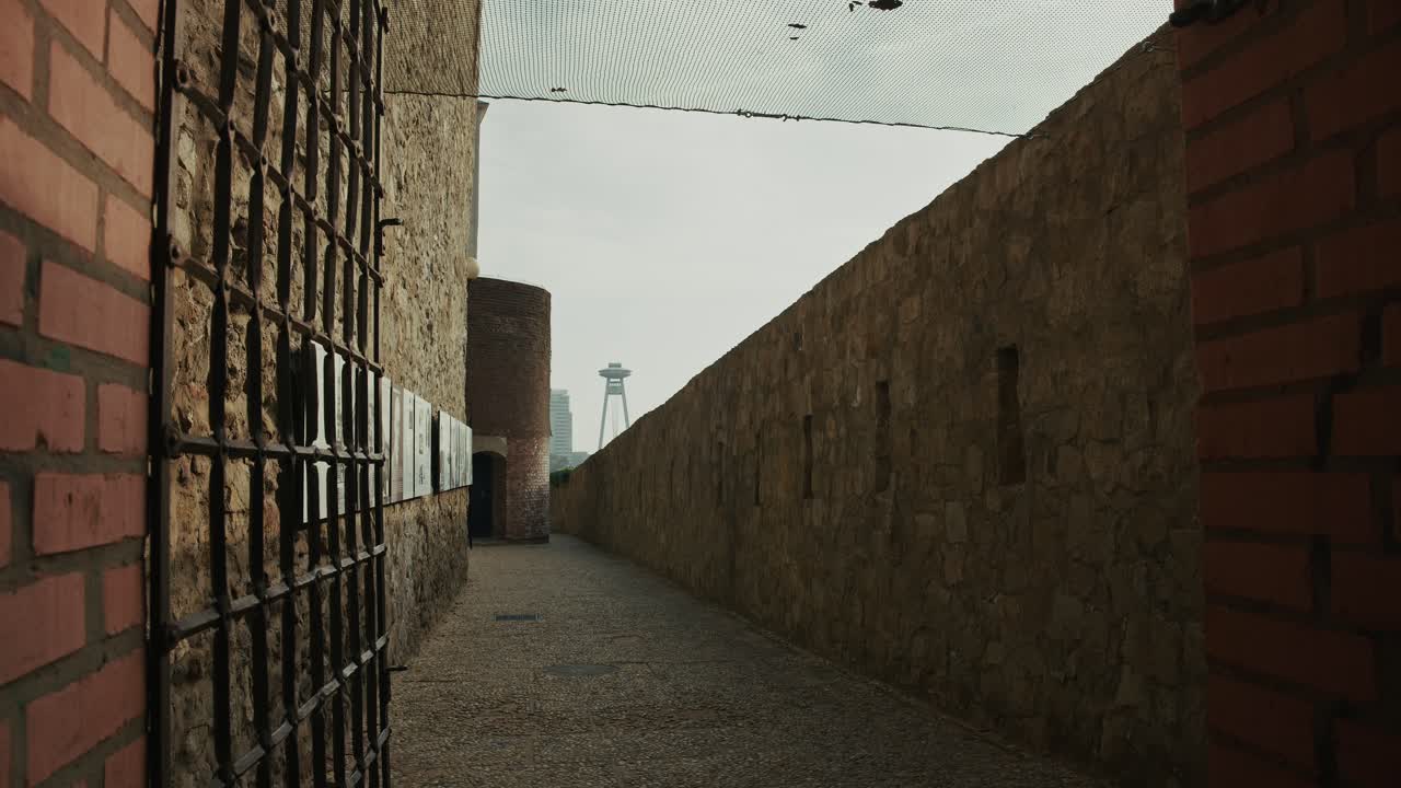 narrow stone passageway, where history whispers through every rugged wall and rusted grate