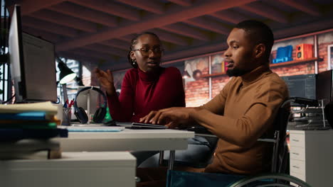manager coming to inclusive startup employee in wheelchair to offer help