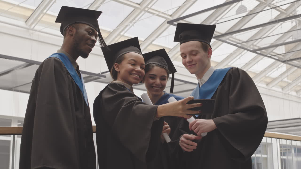 Group of Four Young Graduates Making Selfie