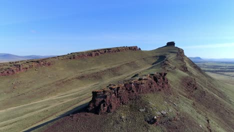 aerial view of a mountain peak with a steep cliff face