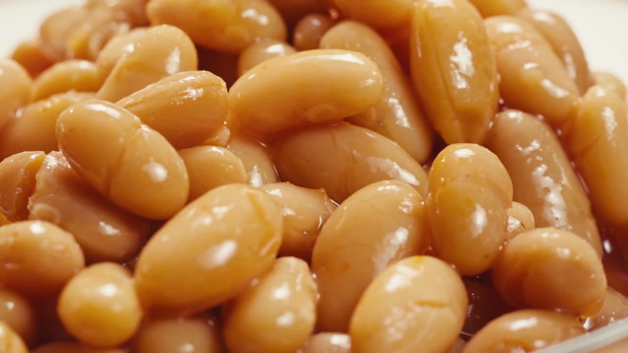 Canned red bans preserved beans rotating background close up side view. Organic steamed beans. Pickled bean for a Mexican dish