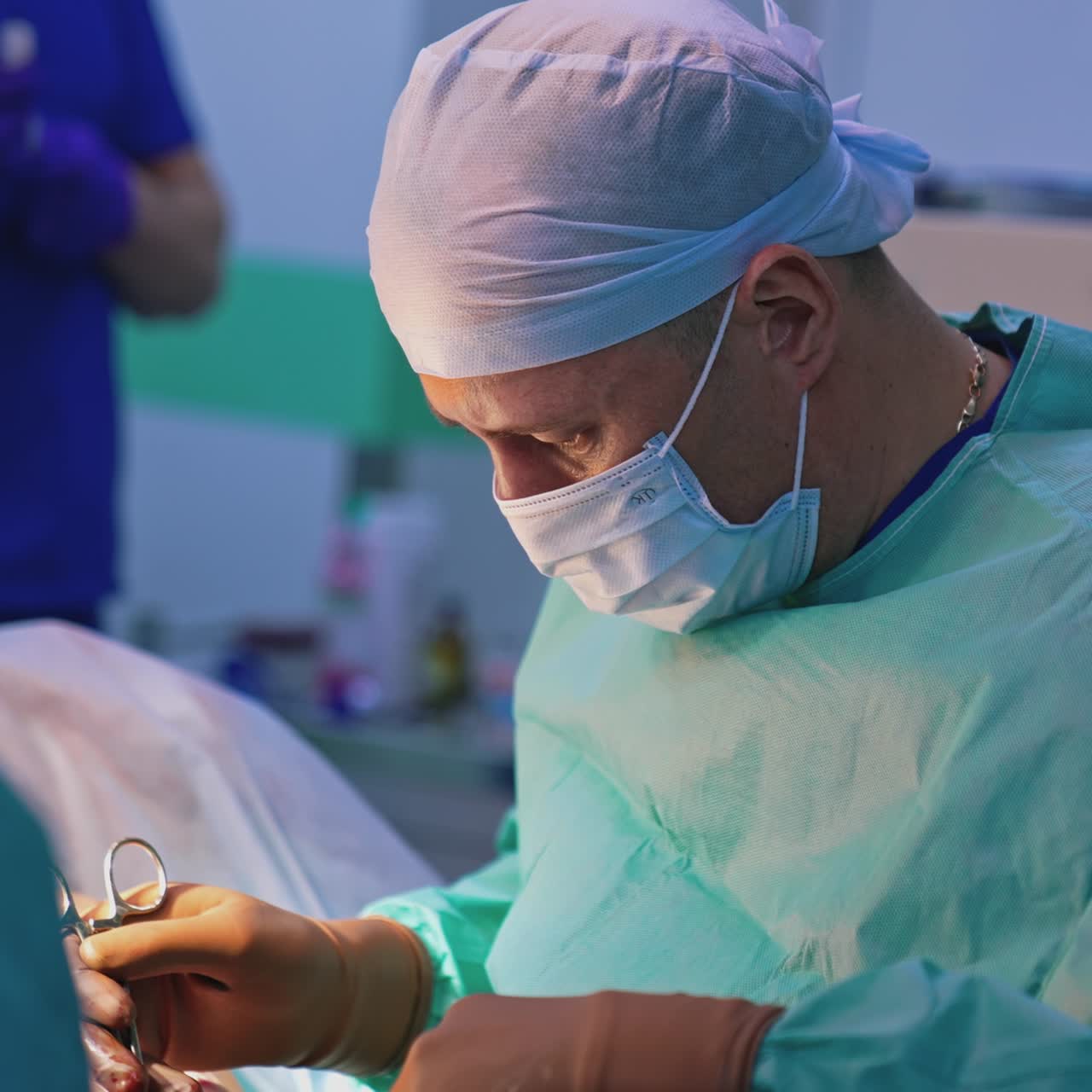 Professional surgeon doing plastic surgery. Doctor conduct a plastic operation with medical tools in clinic. Plastic doctor uses surgical scissors