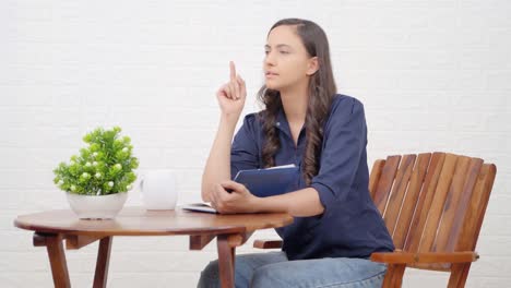 indian girl get an idea while reading a book