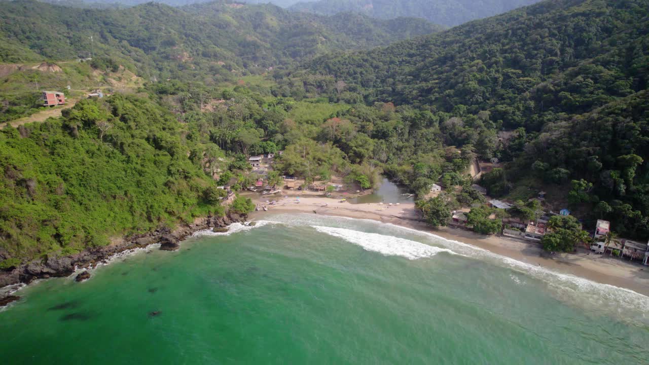 Playa osma, tropical beach surrounded by lush green mountains, aerial view