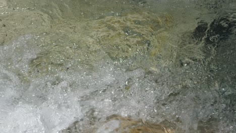 closeup of wild mountain river flowing clear water flowing smoothly in forward direction.