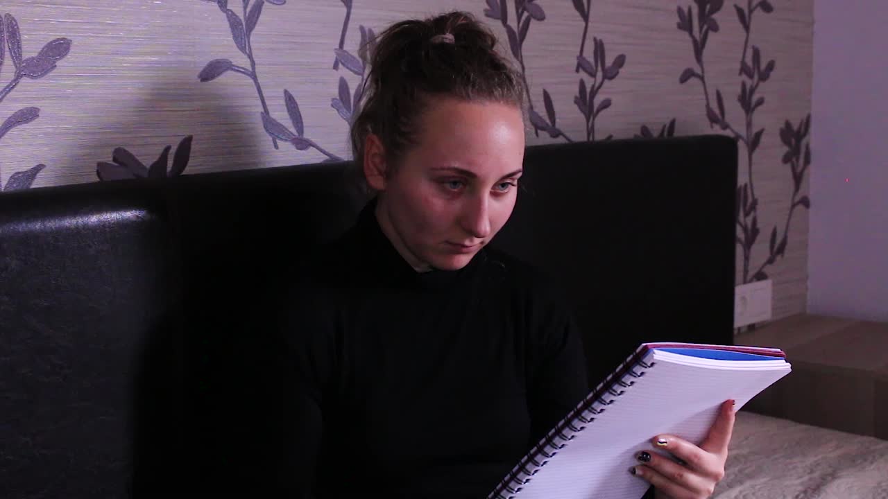 Teenage girl sitting down and solving school homework