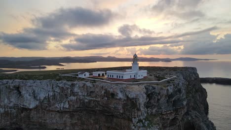 lighthouse in northern menorca on the edge of a clifftop