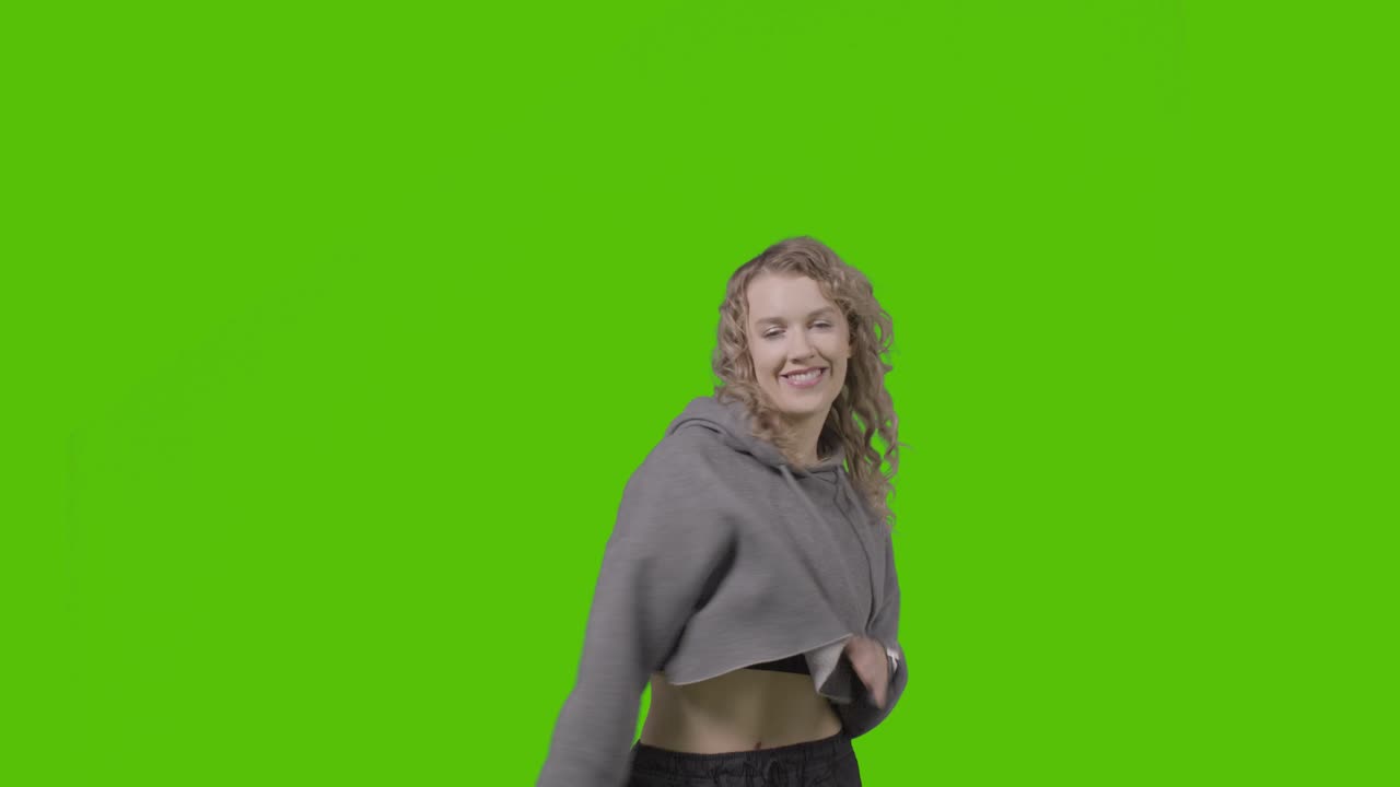 Studio Shot Of Young Woman Having Fun Dancing Against Green Screen 18