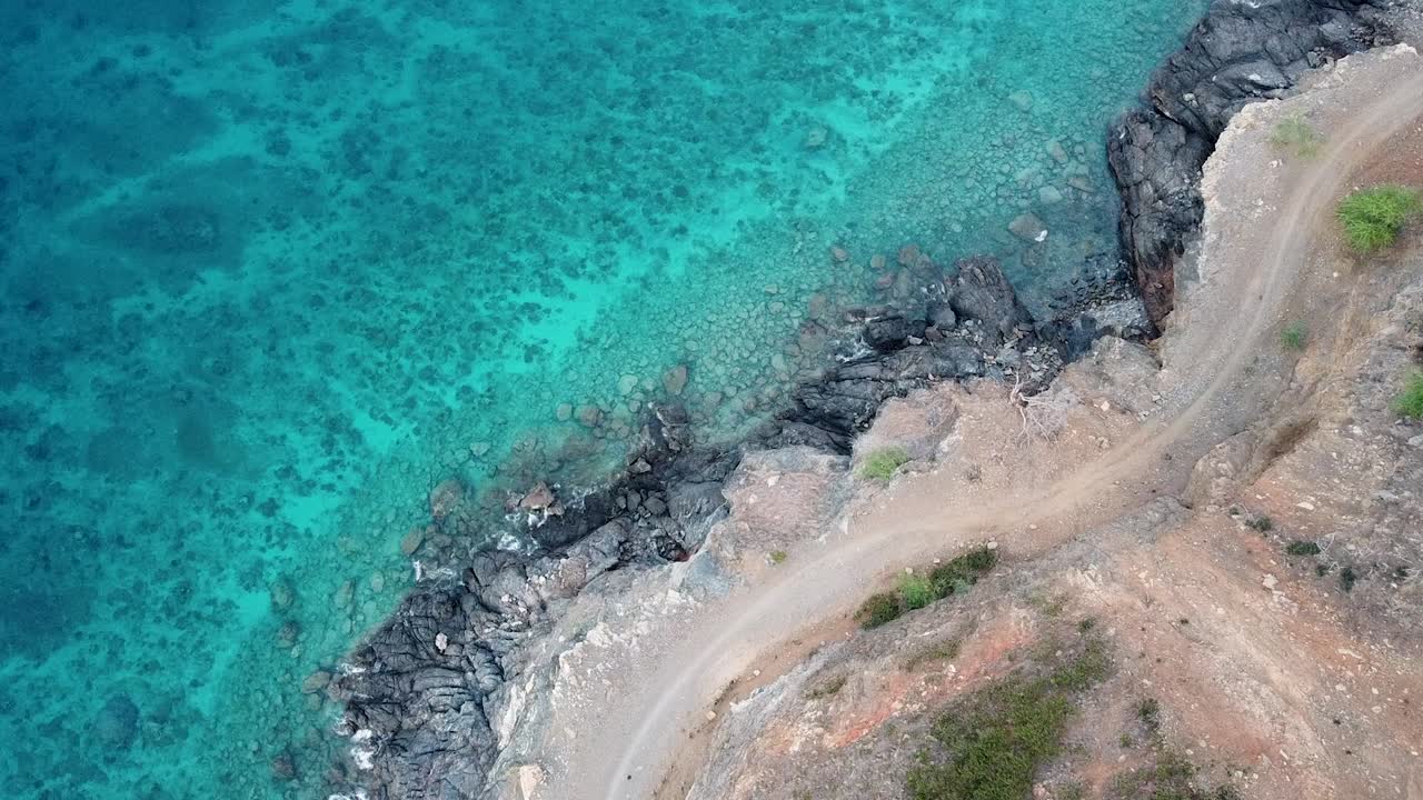Aerial birds eye view of rugged coastal landscape with turquoise ocean water on tropical island of Timor-Leste, Southeast Asia