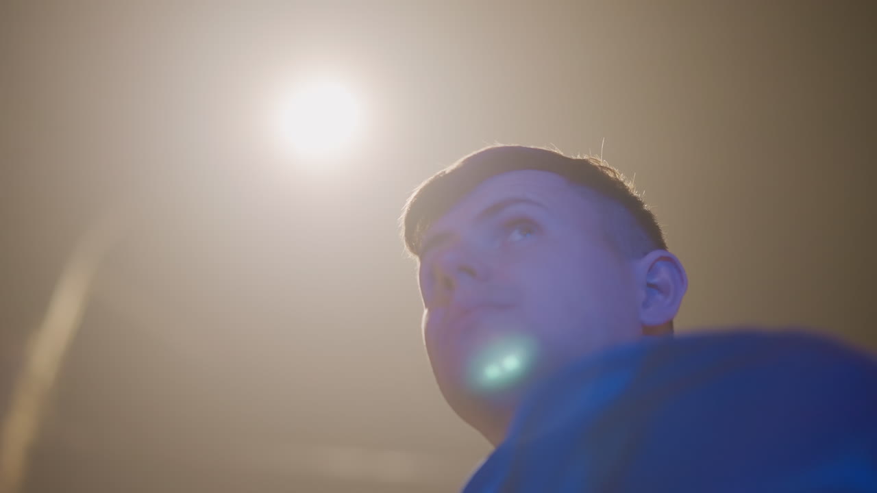Urban night portrait of thoughtful young man, Contemplative young driver illuminated by streetlights at night, Cinematic image capturing young driver under city lights with reflective mood