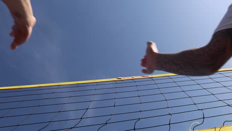 beach volleyballball players giving high five.