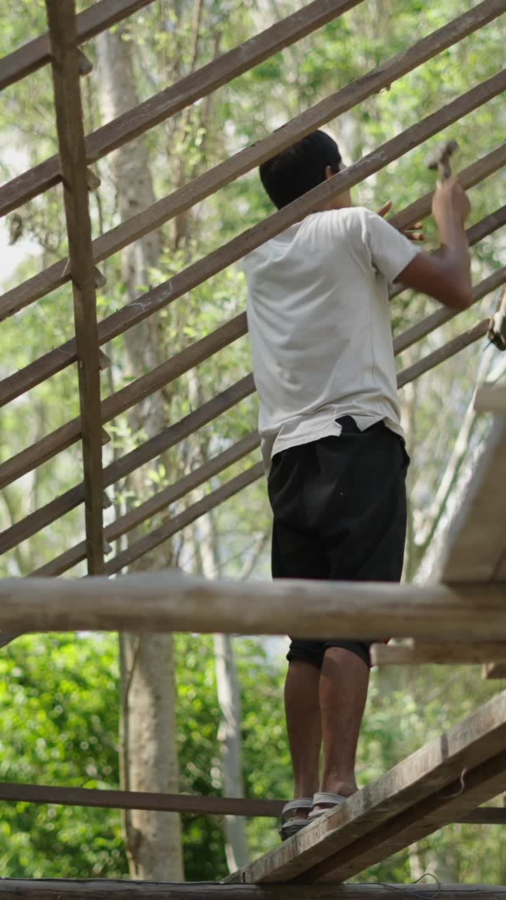 Man working on a wooden structure