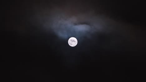 the super moon plays peekaboo with the moody clouds in this sped up video of drama in the sky