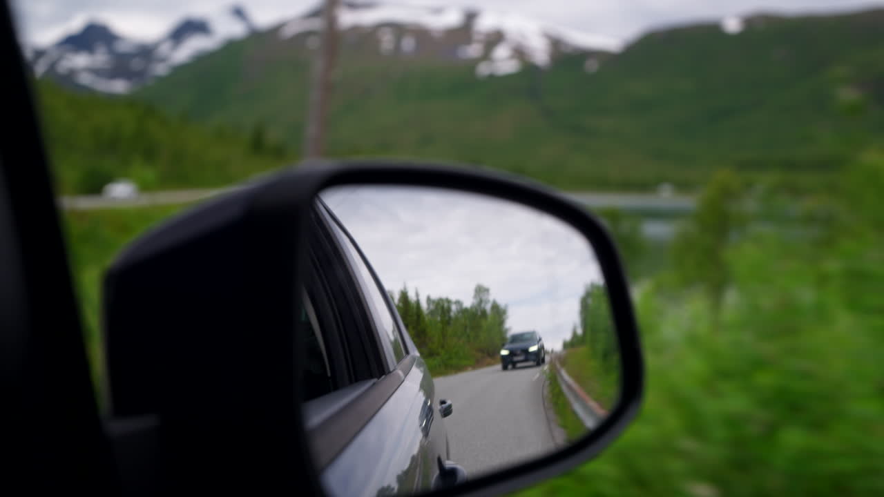 View From A Side Mirror Of A Traveling Car In Northern Norway. POV Shot