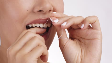 woman flossing her teeth