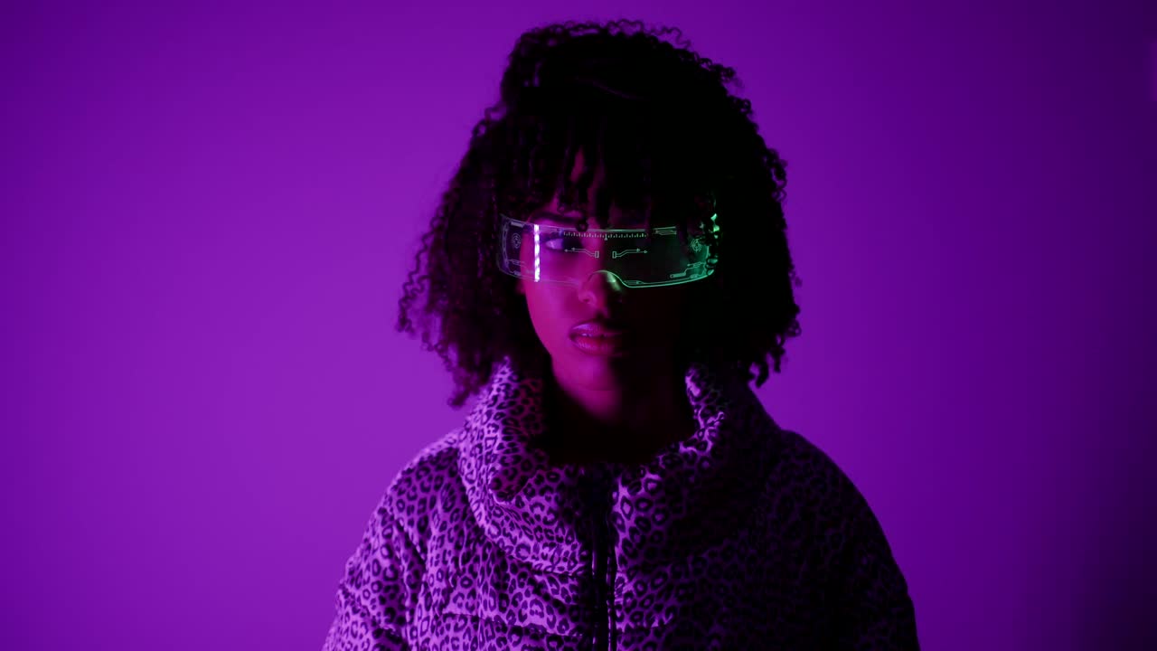 Woman in Futuristic Glasses with Purple Neon Lighting
