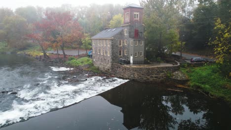 historic delaware mill drone of stream on foggy morning with amazing autumn leaves