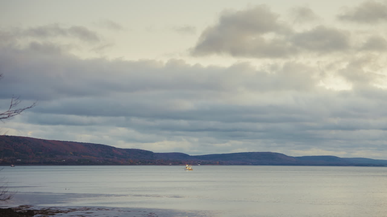 Static shot at the seaside. View of the coastline, the sea and the cloudy sky. Winter landscape.