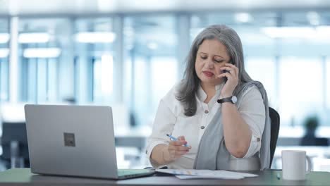 Angry-Indian-senior-female-manager-shouting-on-phone