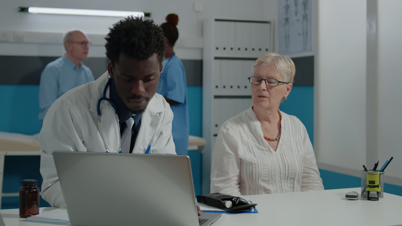 Otologist doing ear consultation for elder patient