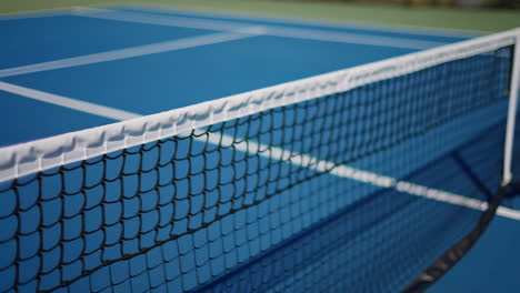 Empty Blue Tennis Court with Net