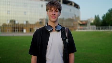 portrait of a young man smiling outdoors