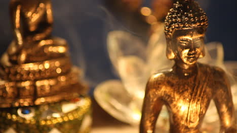 Buddha-statue-with-candle-lights-and-incense-smoke-close-up-13