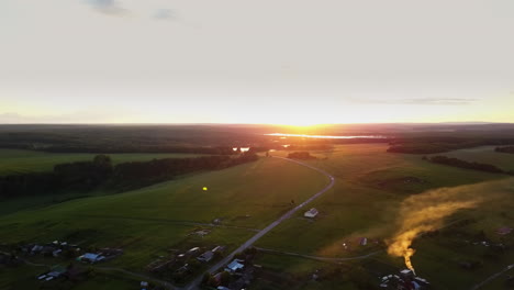 sunrise or sunset over rural village landscape