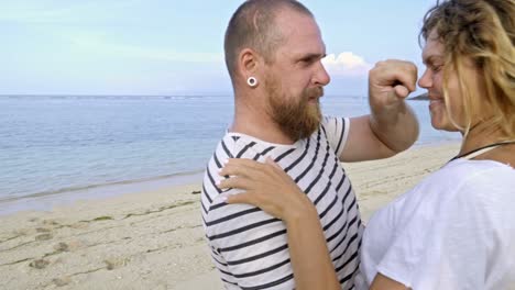 lovely couple bonding on ocean beach