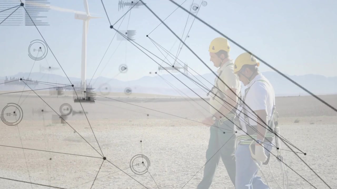 Two workers initiating energy inspection by walking site and monitoring turbine via data overlays