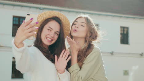 two happy friends taking a selfie outdoors