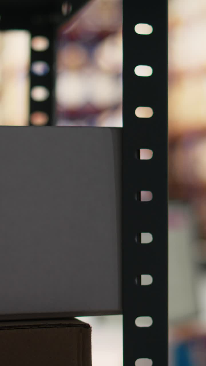 Vertical Video Asian warehouse worker scanning shipping labels and barcodes on packages