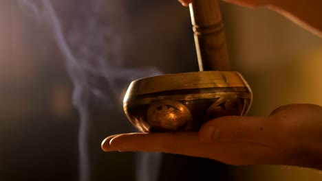 man playing on tibetian singing bowl