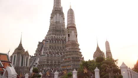 looking-up-at-towering-detailed-pagoda-spires-in-a-buddhist-temple-complex-in-the-Rattanakosin-old-town-of-Bangkok,-Thailand