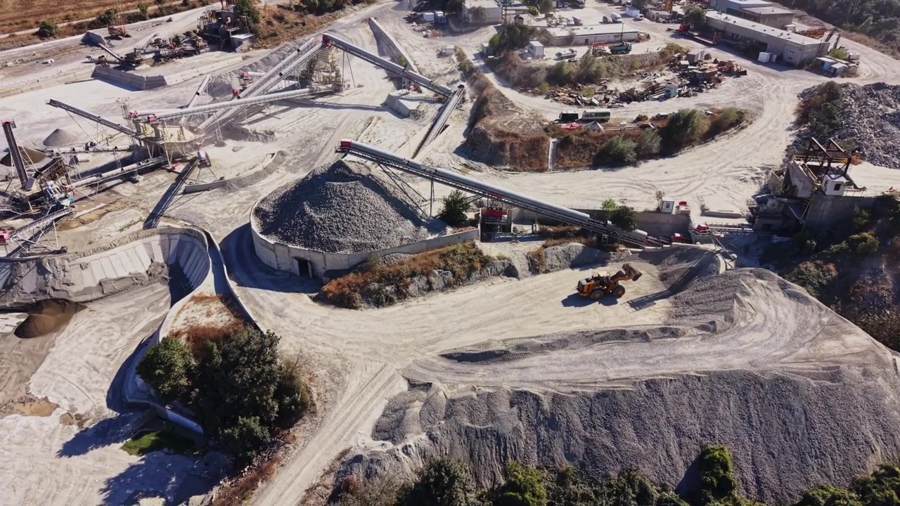 Construction site with machinery and material in a mountainous area