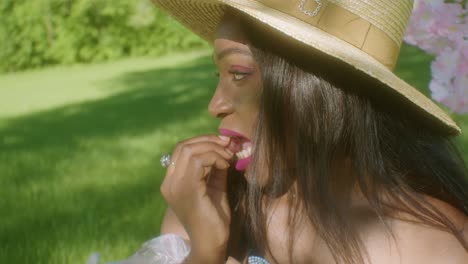 Black-Woman-eating-grapes-in-the-park