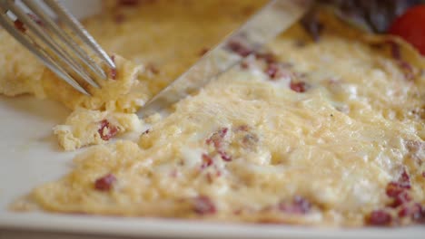 cutting into an omelette