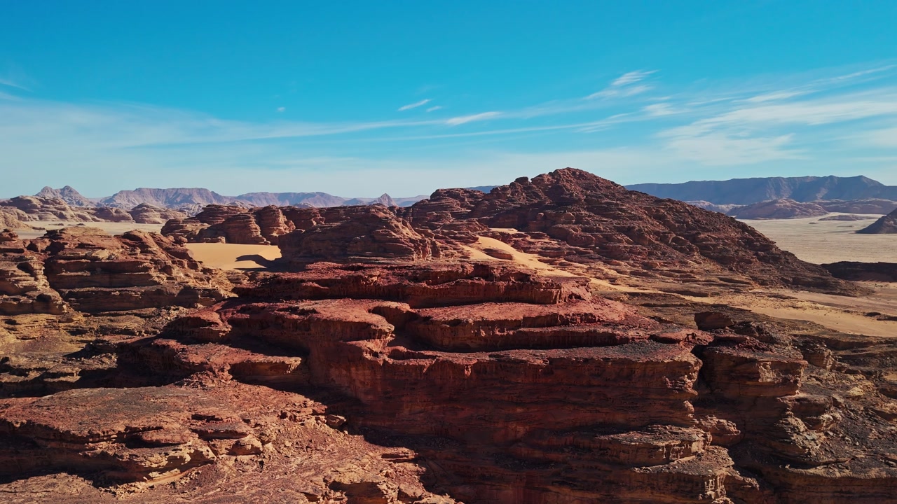 Side drone around rocky mountains in wadi rum desert in jordan