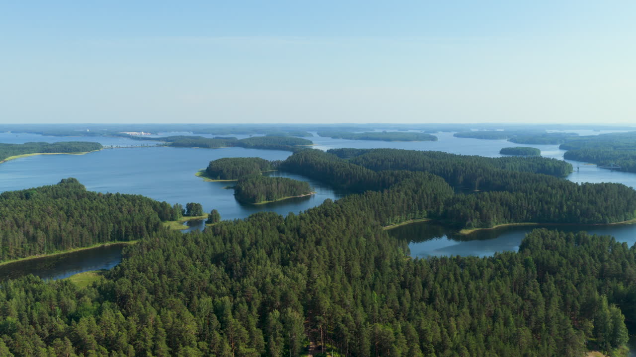 Aerial view rotating over lakelands and greenery of Saimaa, summer in Finland