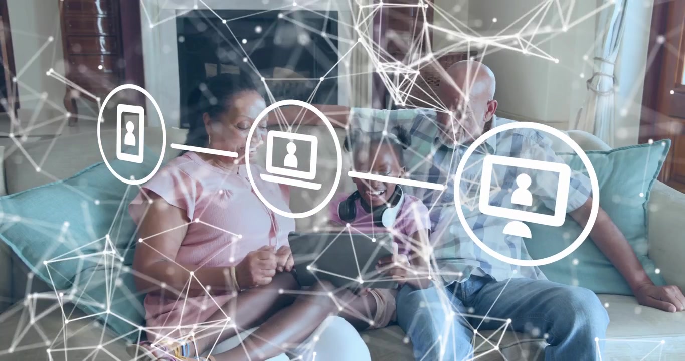 Grandmother pointing tablet granddaughter tapping screen as network icons showing home connectivity