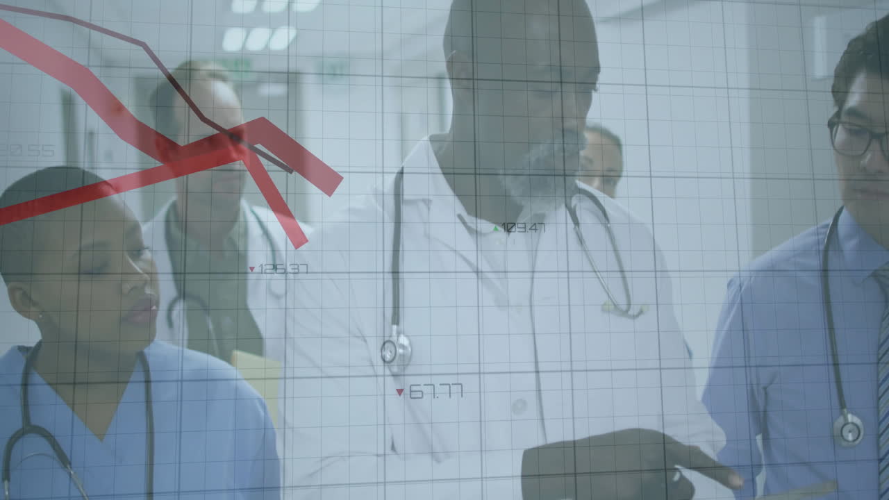 Medical team analyzing patient data in hospital corridor, showing animated grid with red line graph