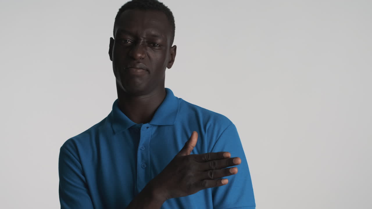 Displeased African american man on grey background.
