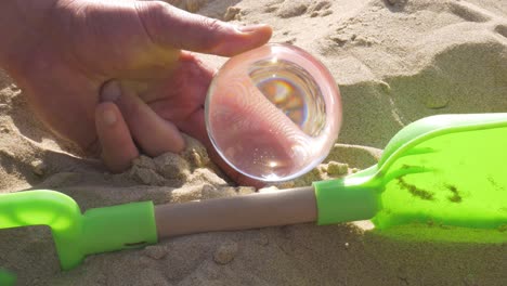 burning a piece of wood on the ground with a crystal ball using solar energy from the sun - close up