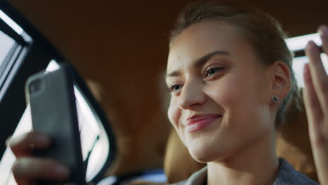 businesswoman waiting for video call at car