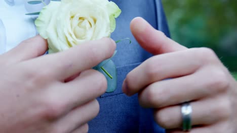 groom adjusting rose on his blazer 4k 4k